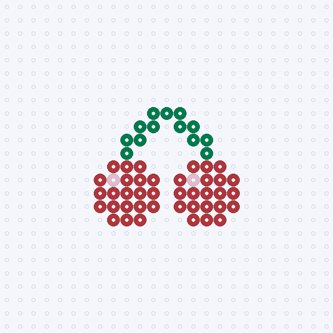 Two red cherries joined by arching dark green stems, each with a light pink highlight on its left side, on a pegboard grid.