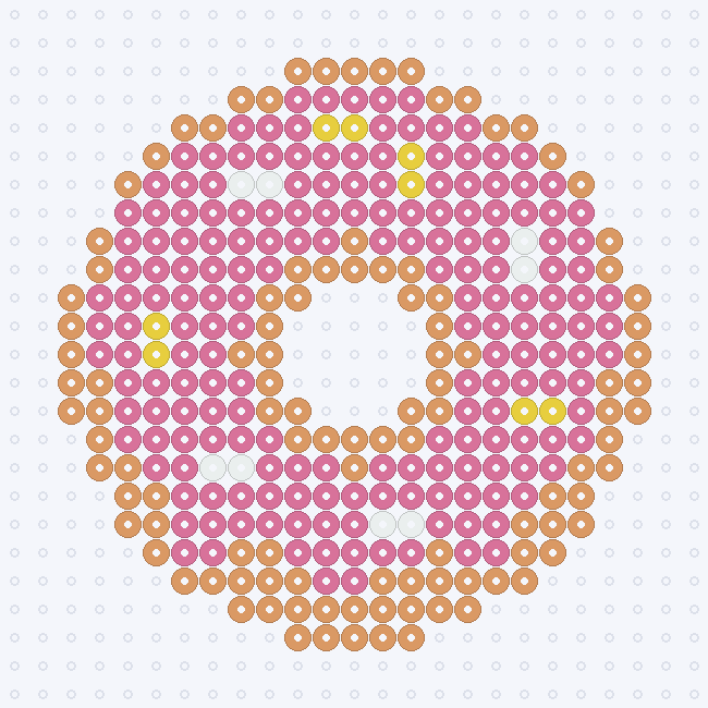 A Butterscotch donut with Bubblegum icing, White and Yellow sprinkles and an open center, on a pegboard grid.