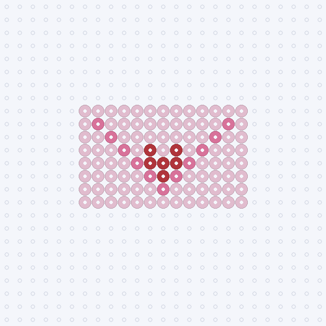 A light pink envelope with darker pink flap lines and a small red heart in the middle as a fuse-bead pattern on a pegboard grid.