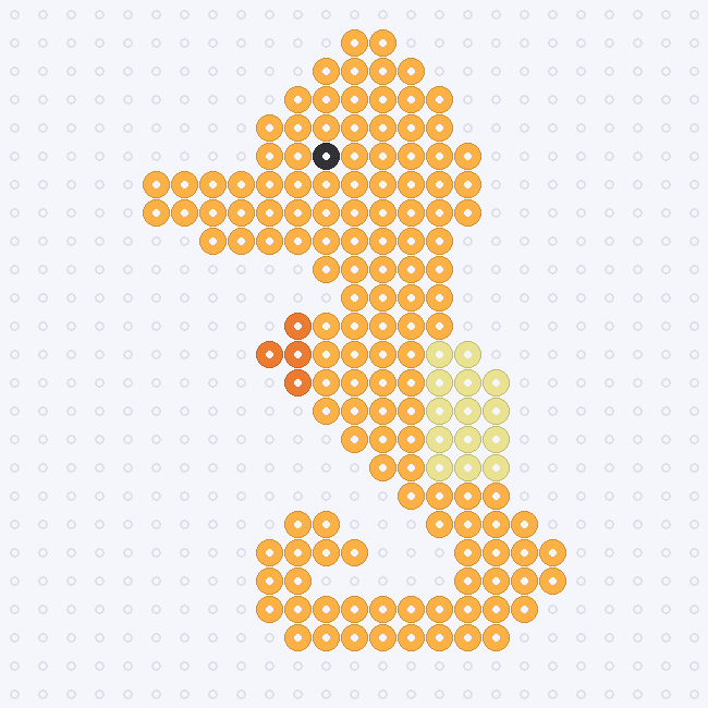 A Cheddar seahorse with a long snout, curled tail, Orange back fin, Pastel Yellow belly and a Black eye, on a pegboard grid.